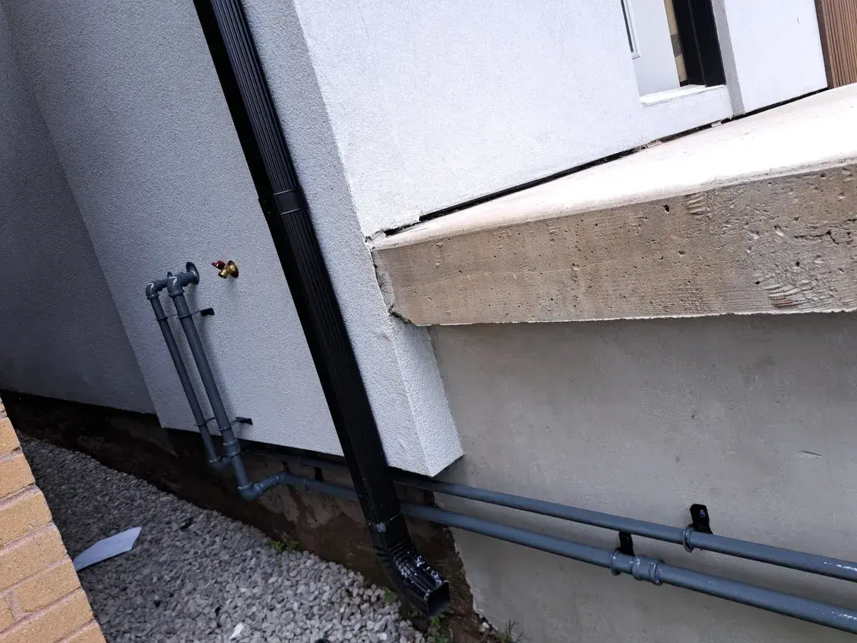 New exterior gas line run along a house foundation